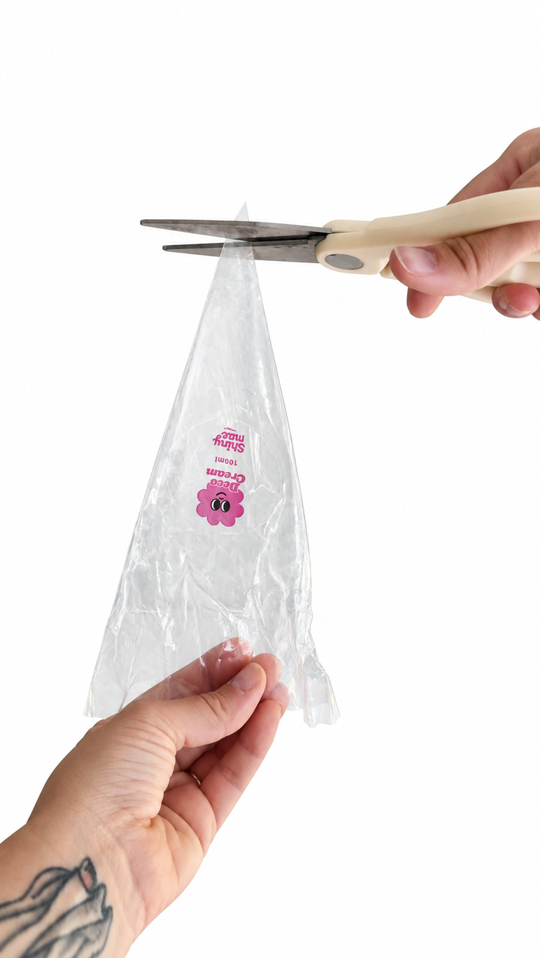 Cut about 1 inch from the tip of the clear outer bag.
